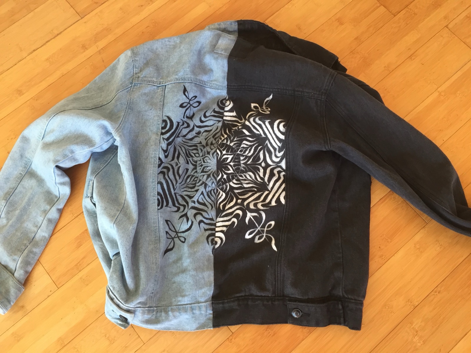 Two-tone denim jacket, light and dark wash, hand-painted with a matching mandala design across the back
